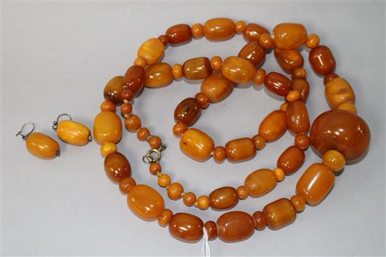 A part amber bead necklace and a pair of amber bead earrings.